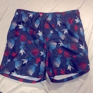 Swimming trunks with a pineapple pattern.